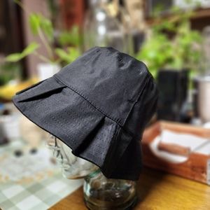 Justin Gregory pleated bucket hats